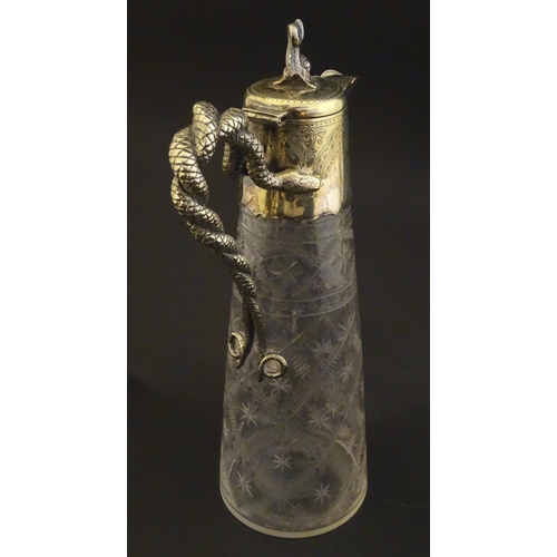 227 - A cut glass claret jug with cut decoration and silver plate mounts, the handle formed as entwined sn... 