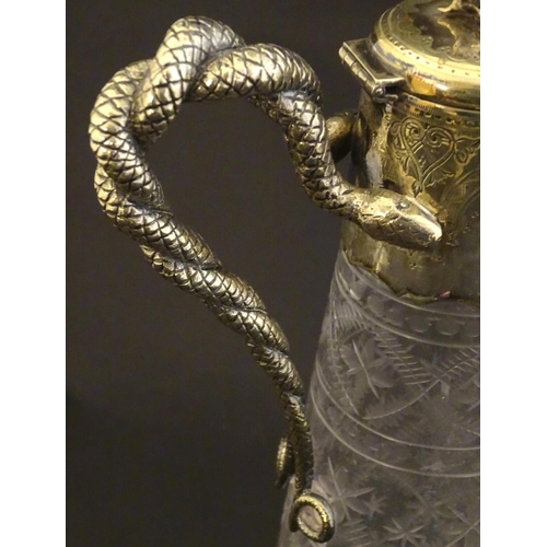 227 - A cut glass claret jug with cut decoration and silver plate mounts, the handle formed as entwined sn... 