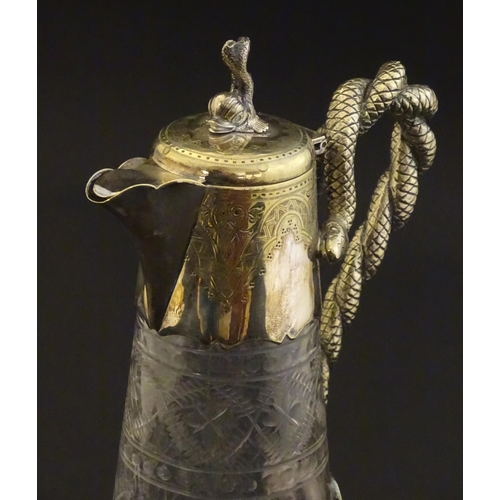 227 - A cut glass claret jug with cut decoration and silver plate mounts, the handle formed as entwined sn... 