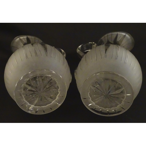 228 - A pair of 19thC jugs with etched decoration depicting floral and foliate detail probably by Richards... 