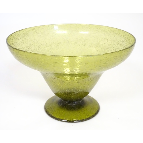 229 - A green glass pedestal bowl with bubble inclusions. Approx 11 1/2