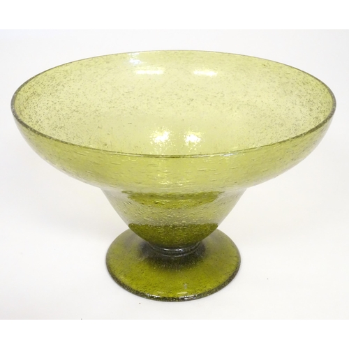 229 - A green glass pedestal bowl with bubble inclusions. Approx 11 1/2