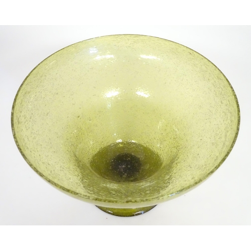 229 - A green glass pedestal bowl with bubble inclusions. Approx 11 1/2