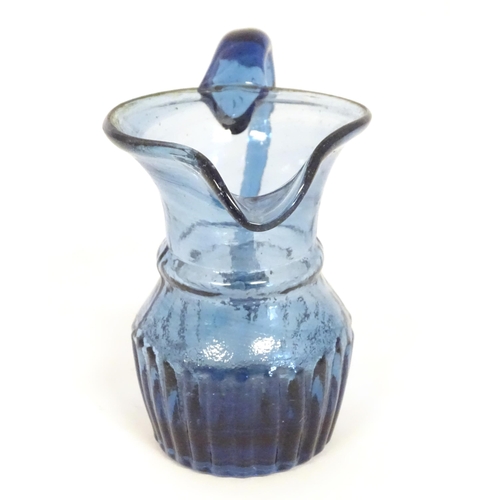 231 - A blue glass cream jug with loop handle. North East England c.1830. 4