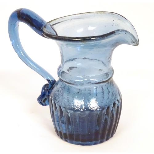 231 - A blue glass cream jug with loop handle. North East England c.1830. 4