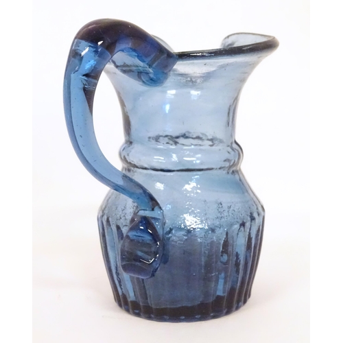 231 - A blue glass cream jug with loop handle. North East England c.1830. 4