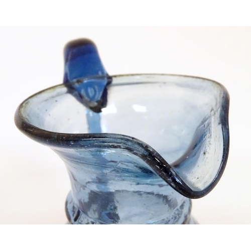 231 - A blue glass cream jug with loop handle. North East England c.1830. 4