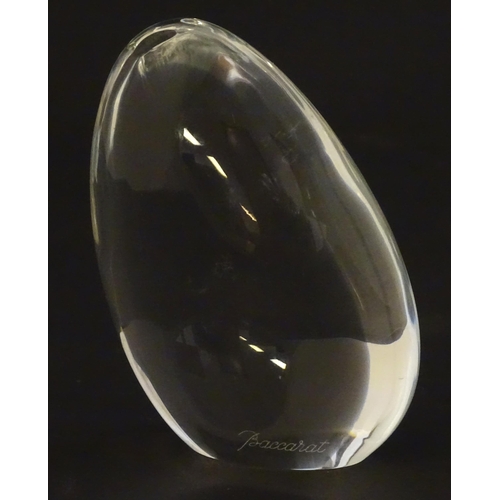 236 - Baccarat glass: a clear glass pebble shaped paperweight with Baccarat makers mark to base. Approx 3 ... 