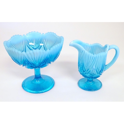 242 - A Davidson blue glass cream jug and pedestal sugar bowl. The bowl 5 1/4