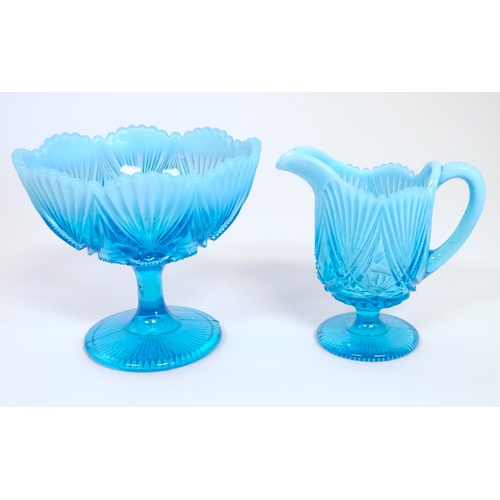 242 - A Davidson blue glass cream jug and pedestal sugar bowl. The bowl 5 1/4