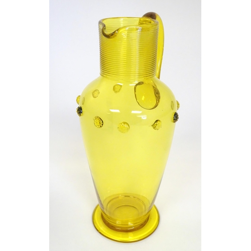 252 - A Victorian yellow glass jug with punt decoration. Approx 10 1/4