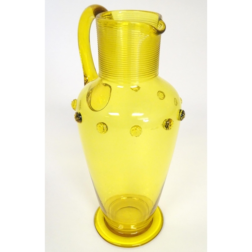 252 - A Victorian yellow glass jug with punt decoration. Approx 10 1/4