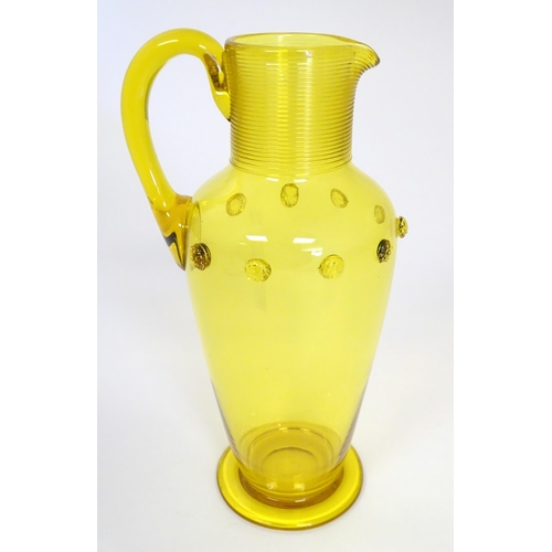 252 - A Victorian yellow glass jug with punt decoration. Approx 10 1/4