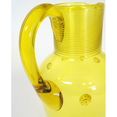 252 - A Victorian yellow glass jug with punt decoration. Approx 10 1/4