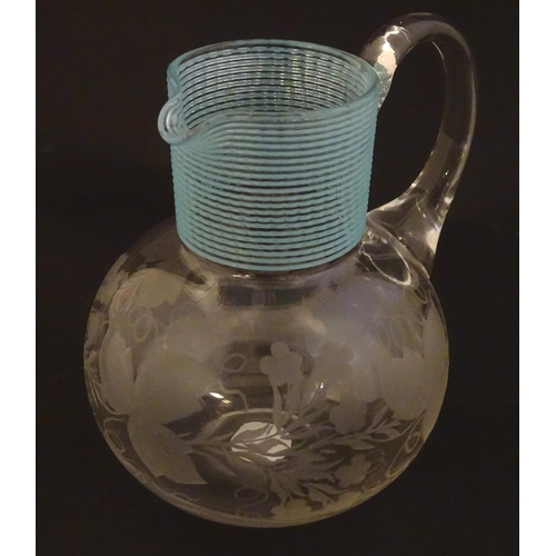 253 - A Victorian water jug with engraved floral and foliate decoration and turquoise banding. Approx. 5 1... 