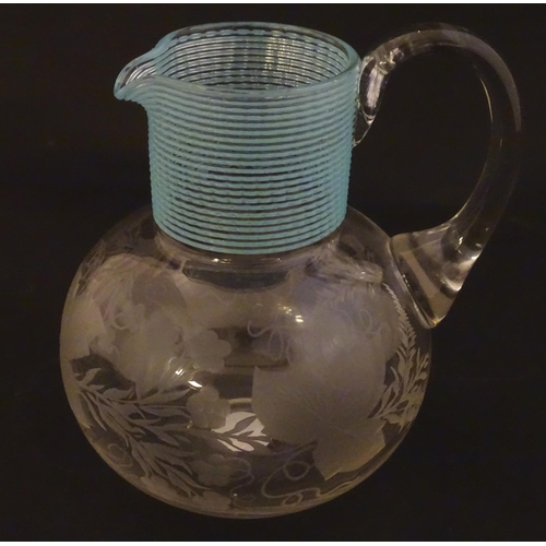 253 - A Victorian water jug with engraved floral and foliate decoration and turquoise banding. Approx. 5 1... 