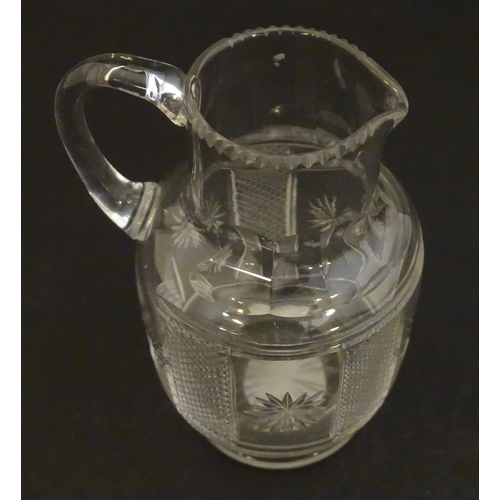 263 - A Victorian glass cream jug and sugar bowl with cut decoration. The jug 3 1/4