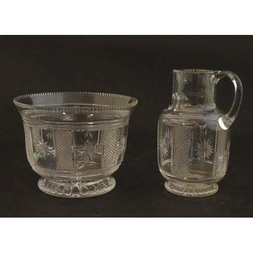 263 - A Victorian glass cream jug and sugar bowl with cut decoration. The jug 3 1/4