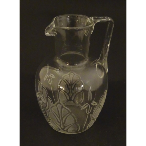 266 - A glass water jug with foliate detail Approx 7