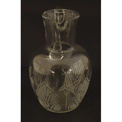 266 - A glass water jug with foliate detail Approx 7