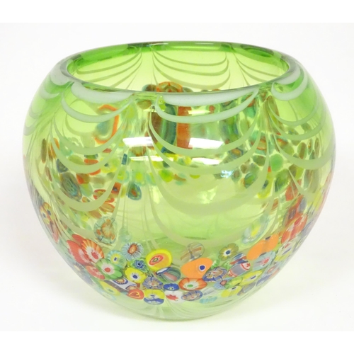 273 - A green glass bowl with millefiori style decoration. Approx  7 1/2