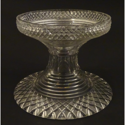 277 - A 19thC cut glass pineapple stand with wide flared foot cut with a hobnail band rising to a stepped ... 