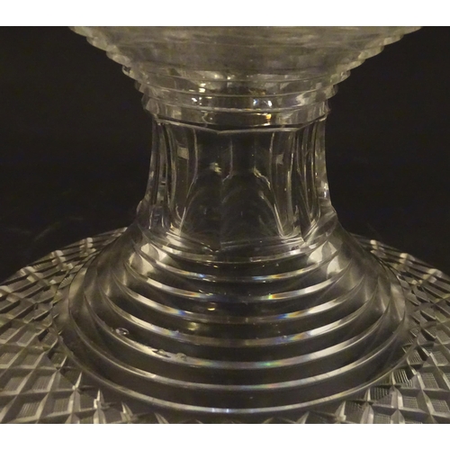 277 - A 19thC cut glass pineapple stand with wide flared foot cut with a hobnail band rising to a stepped ... 