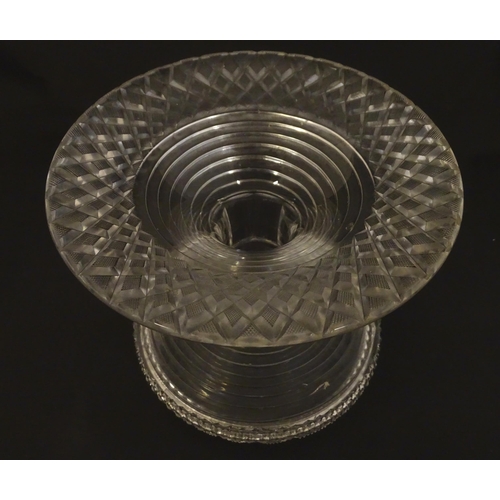 277 - A 19thC cut glass pineapple stand with wide flared foot cut with a hobnail band rising to a stepped ... 