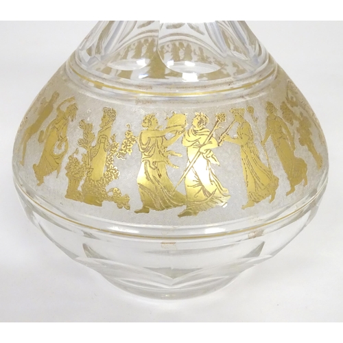 279 - An early 20thC glass decanter with banded gilt detail depicting classical figures. Probably by Moser... 