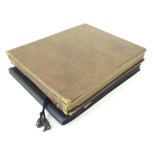 945 - Two early 20thC photograph albums to include portraits, group photos, motorbikes, cars, boats, bipla... 