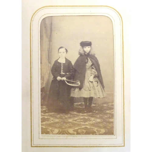 949 - A Victorian carte de visite photograph album containing various portrait cards and prints.