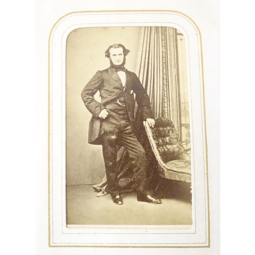 949 - A Victorian carte de visite photograph album containing various portrait cards and prints.