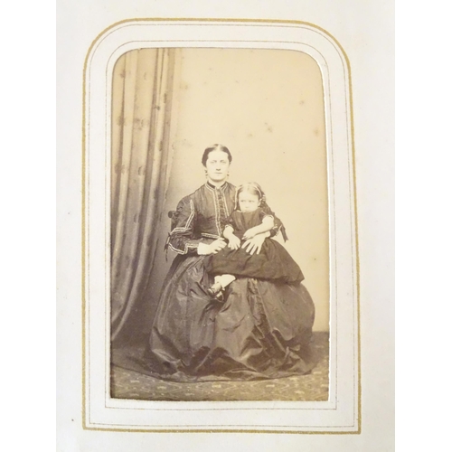 949 - A Victorian carte de visite photograph album containing various portrait cards and prints.