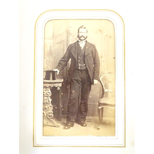 949 - A Victorian carte de visite photograph album containing various portrait cards and prints.