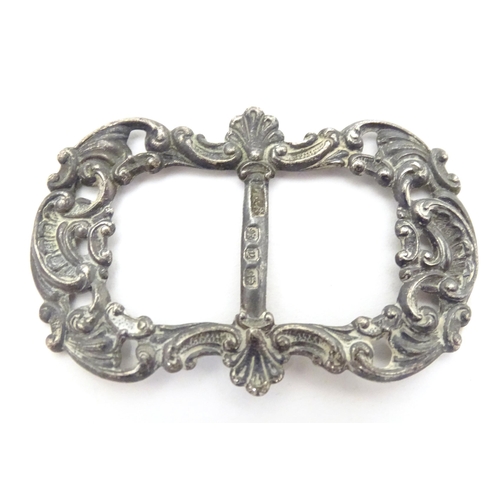 473A - A Victorian silver buckle hallmarked Birmingham 1898, maker Levi & Salaman. Together with a white me... 