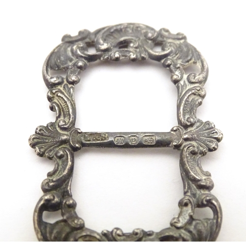 473A - A Victorian silver buckle hallmarked Birmingham 1898, maker Levi & Salaman. Together with a white me... 