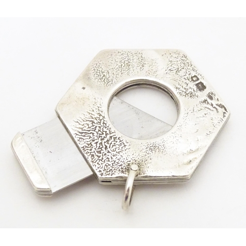 476A - A silver cigar cutter of hexagonal pendant form, hallmarked London 1972, maker Ramsdon and Roed. App... 