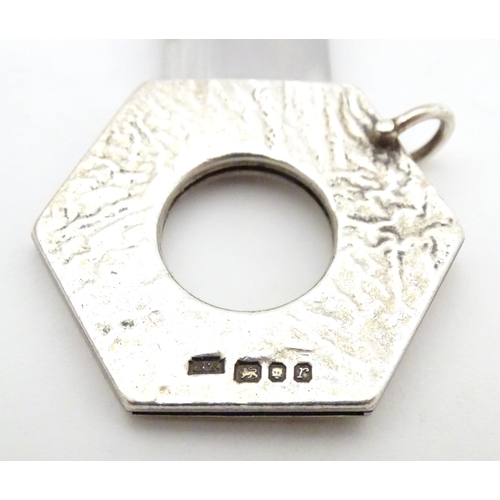 476A - A silver cigar cutter of hexagonal pendant form, hallmarked London 1972, maker Ramsdon and Roed. App... 