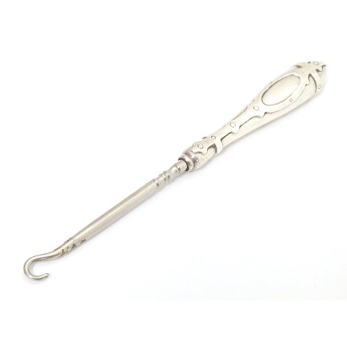 530 - A sterling silver handled button hook with strapwork detail to handle. Approx. 6 1/2