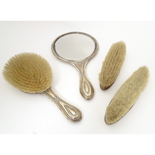 538 - A silver dressing table set comprising hand mirror and brushes, hallmarked Birmingham 1907 & 1921, m... 