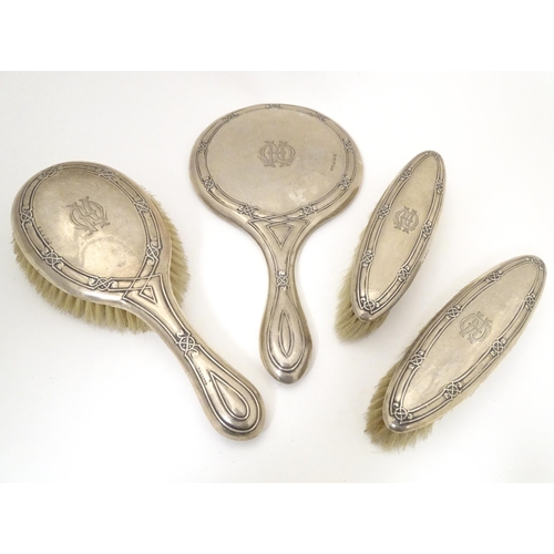 538 - A silver dressing table set comprising hand mirror and brushes, hallmarked Birmingham 1907 & 1921, m... 