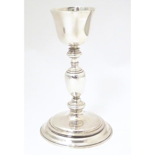 545 - Ecclesiastical silver: A silver communion chalice and paten both with engraved cross decoration, bot... 