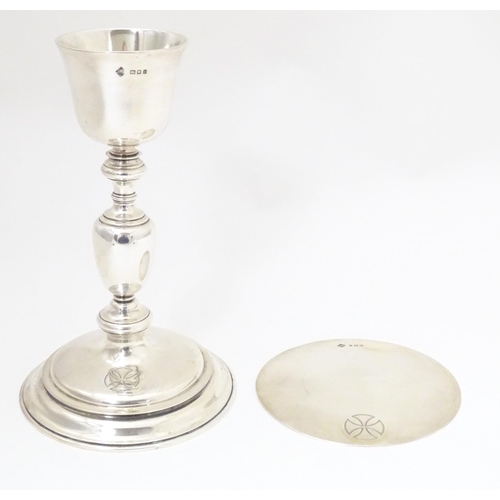 545 - Ecclesiastical silver: A silver communion chalice and paten both with engraved cross decoration, bot... 