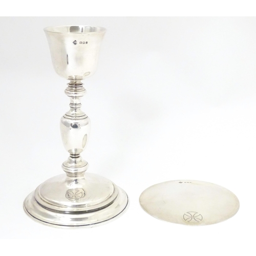 545 - Ecclesiastical silver: A silver communion chalice and paten both with engraved cross decoration, bot... 