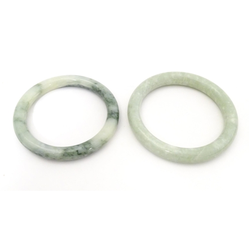 715 - A quantity of assorted bangle bracelets, some jade hardstone examples. (8)