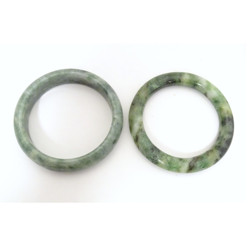 715 - A quantity of assorted bangle bracelets, some jade hardstone examples. (8)