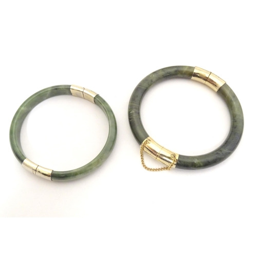 715 - A quantity of assorted bangle bracelets, some jade hardstone examples. (8)