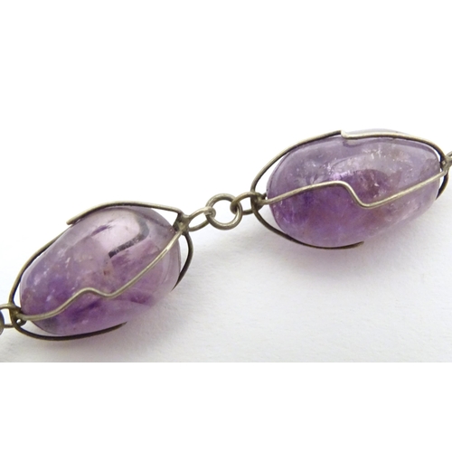 718 - A white metal and amethyst necklace. Approx. 28