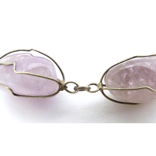 718 - A white metal and amethyst necklace. Approx. 28