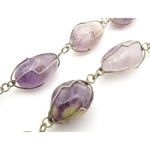 718 - A white metal and amethyst necklace. Approx. 28